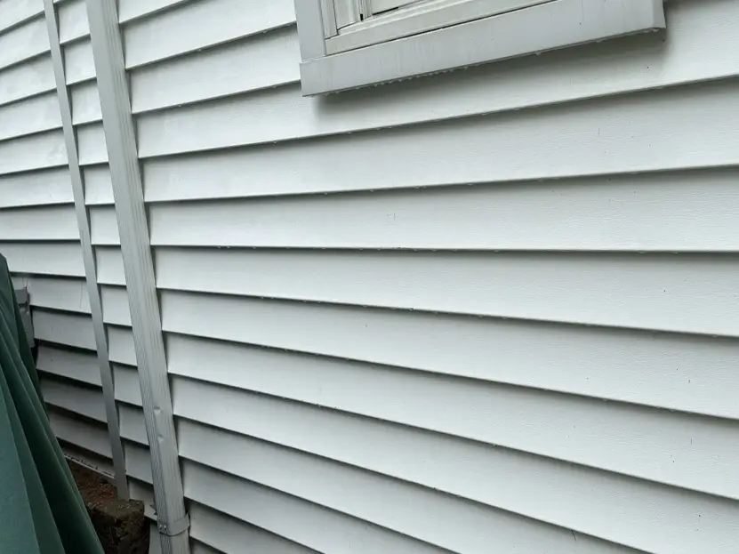 The same white siding rinsed back to clean, even white after a soft wash